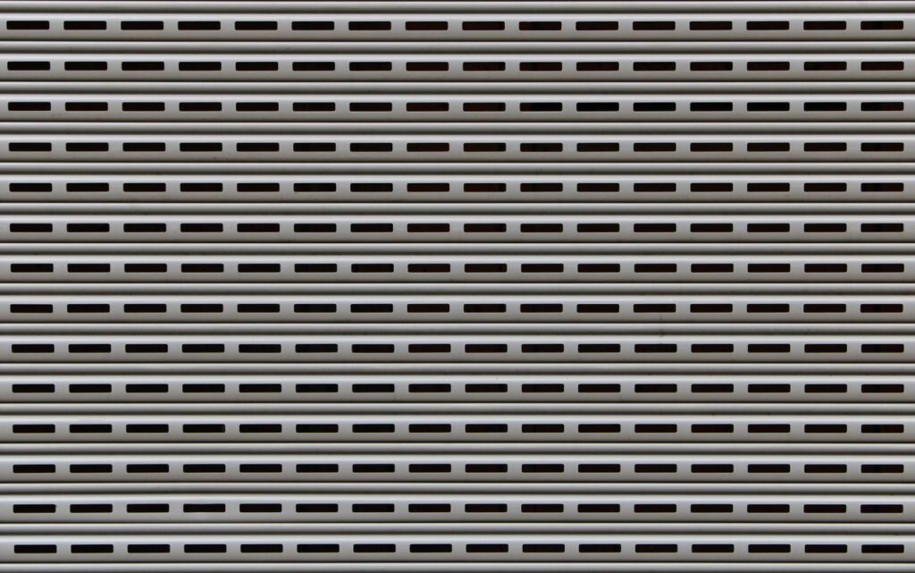 Close-up view of a textured metallic roll-up door showcasing repetitive horizontal patterns.