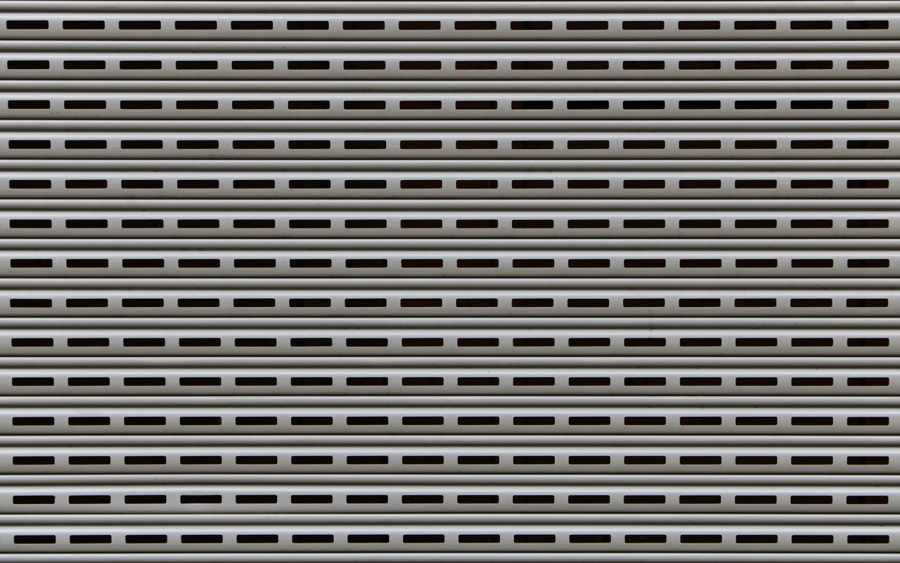 Close-up view of a textured metallic roll-up door showcasing repetitive horizontal patterns.